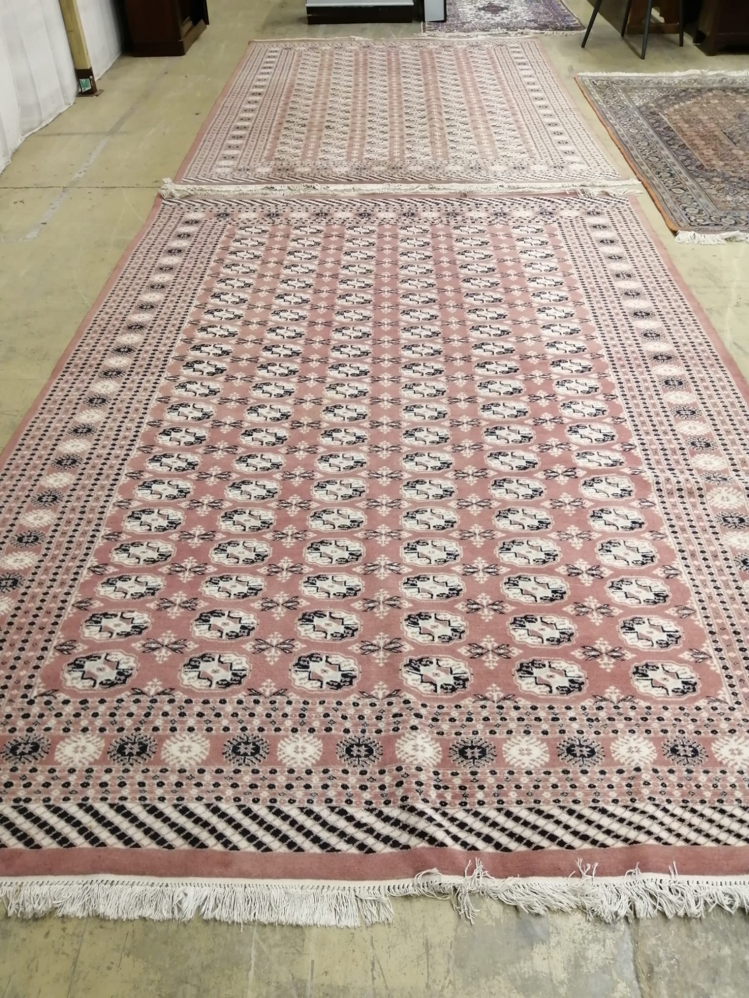 A pair of Bokhara peach ground carpets, 310 x 218cm